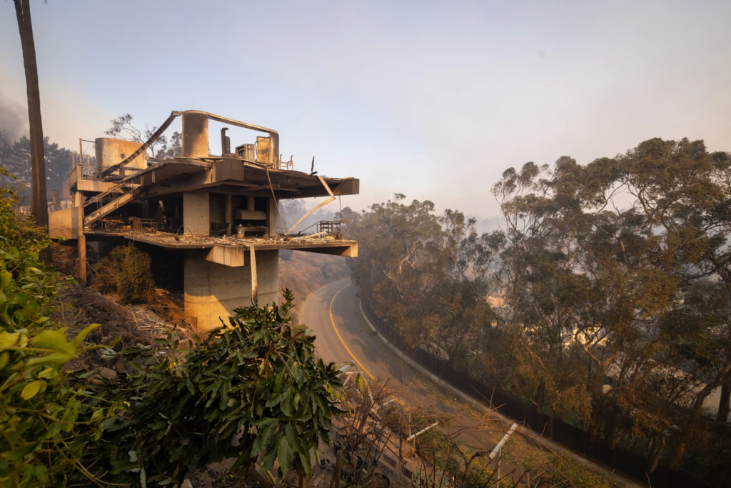 Water is dropped by helicopter on the burning Sunset Fire in Hollywood Hills Wednesday night.
(Brian van der Brug/Los Angeles Times via Getty Images)